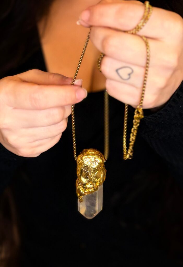 A crystal pendant held in a hand