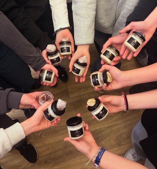 Workshop guests holding up their finished candles